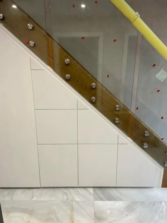 White painted under stairs storage unit with soft-close doors in Stockport home